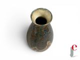 a small vase that is sitting on a white surface