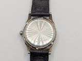 a watch that is sitting on a white surface