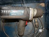 a drill with a cord attached to it in a box