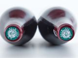 two bottles of wine that are sitting on a table