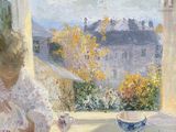 un tableau représentant une femme assise à une table avec une tasse