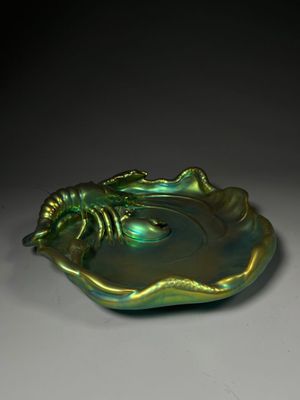 a close up of a green shell shaped object on a table