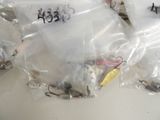 several bags of fishing lures are lined up on a table