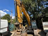 a yellow excavator that is sitting in the dirt