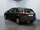 the back of a car is parked in a room with a white wall