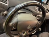 dashboard view of a car with a steering wheel and dashboard controls