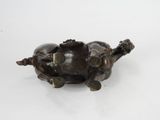 bronze figurine of a turtle on a white surface with a white background