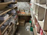 a narrow room with lots of boxes and boxes on the shelves
