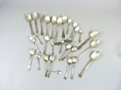 a lot of silver spoons and spoon spoons on the table