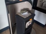 a small black stove in the corner of a room