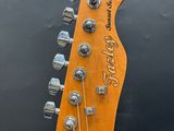 a close up of the headstock of a bass guitar