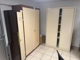 a refrigerator and a refrigerator freezer in a room