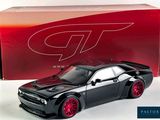 black and red model of a car in front of a red box