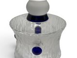 a glass vase that is sitting on a white surface