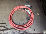 a red hose that is on the ground next to a car door