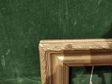 a clock that is sitting on a table in front of a green wall
