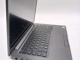 a silver laptop with a black keyboard on a white surface