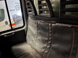 an image of the inside of a bus with the seats down