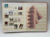 an open book with a bunch of stamps on it