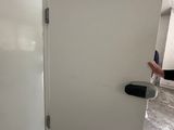 a white door with a black handle in a room