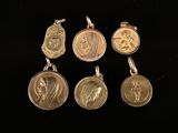 four gold medals with a woman and a man on them