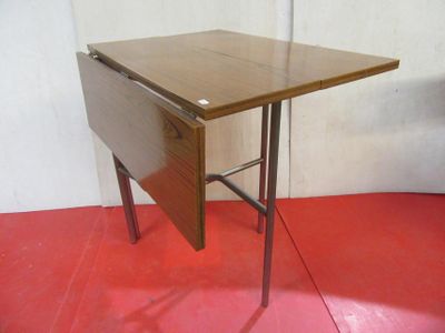 a small wooden table with a folding top on a red floor
