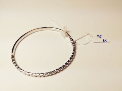 a close up of a silver bracelet with a tag on it