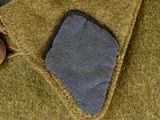 a close up of a jacket with a button on it