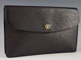 a black louis vuitton clutch bag with gold hardware