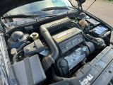 a car engine with its hood open on the street