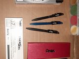 a box with pens, pens, and other items on it