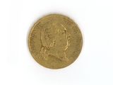 an old gold coin on a white surface with a white background