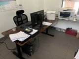 a desk with two monitors and a laptop on it