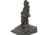 an image of a bronze statue of a woman sitting on a rock