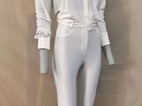 the mannequin is wearing white pants and a white shirt
