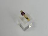 a close up of a gold ring with a ruby stone