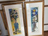 three framed pictures on the wall next to a vase of flowers