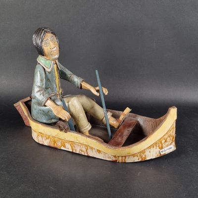 a figurine of a man in a boat on a table