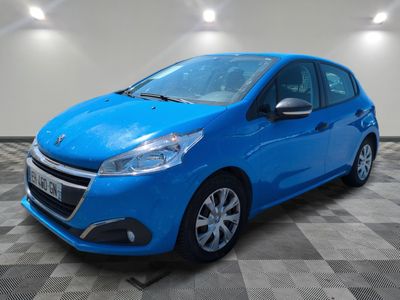 a blue car parked in a garage with a checkered floor