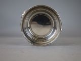 an antique silver plate with a silver rim on a table