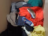 a box full of clothes and a pair of shoes in it