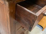 an old wooden desk with a drawer in it