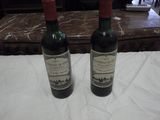 two bottles of wine that are sitting on a table
