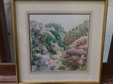 framed watercolor painting of a forest scene in a gold frame