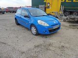 a small blue car parked in a parking lot
