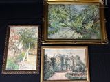 trois tableaux encadrés représentant une maison et un jardin, posés sur une table noire