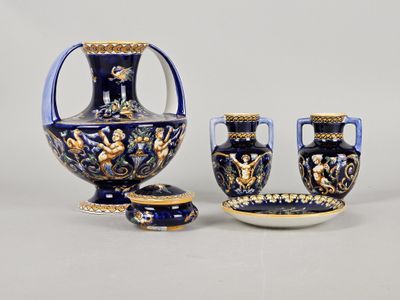 three pieces of blue and gold decorated vases and a bowl