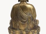 statue of a seated buddha on a lotus - shaped base