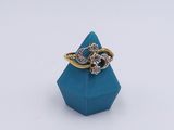 a close up of a ring with a diamond on top of a blue box
