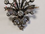 a picture of a brooch that is on a table